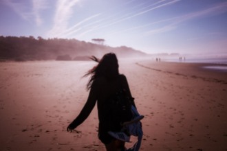 Wild girl runs on the beach